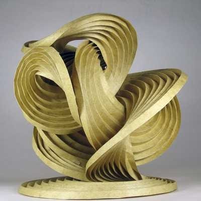 A photo of Erik and Martin Demaine’s early curved-crease origami sculpture, titled “Natural Cycles”.