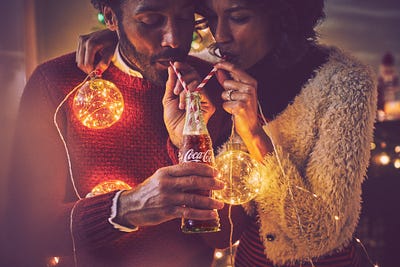 Cocacola brand photography voupledrinking with straws from bottle Cocacola brand photography voupledrinking with straws from bottle