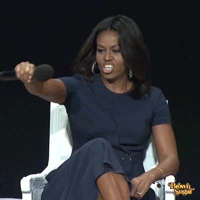 gif of Michelle Obama saying “Drop the mic” while laughing