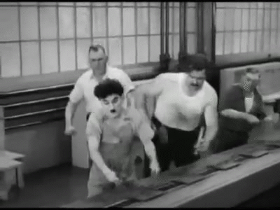 Charlier Chaplin working in a factory.gif