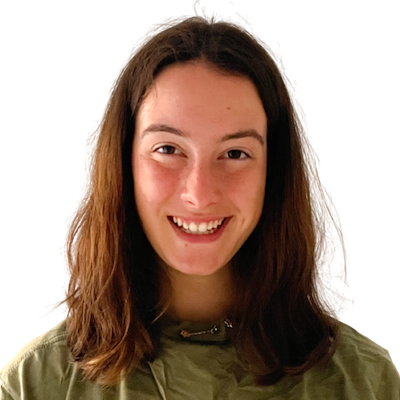 Photo of Sophia, a white woman, from the chest up. She is looking at the camera with an open lipped smile. She is wearing no makeup, a green and gold necklace and a green shirt. Her hair is naturally brushed and parted in the middle.