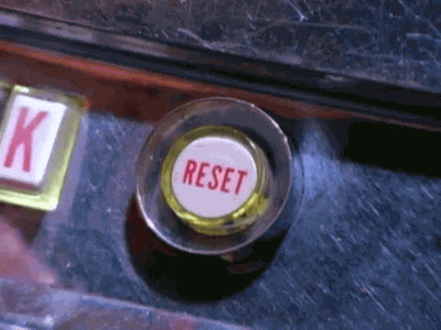 A video clip of a finger pushing a button that is labeled “RESET”.