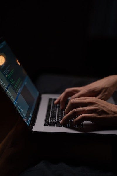 Photo by Pavel Danilyuk: https://www.pexels.com/photo/person-using-silver-and-black-laptop-computer-5496464/