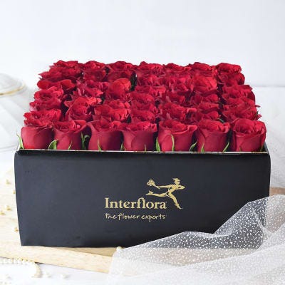 red roses in a box by Interflora India