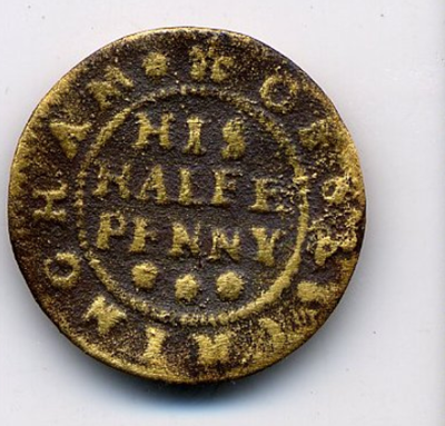 Image of a worn and pitted copper alloy A worn and pitted copper alloy traders token