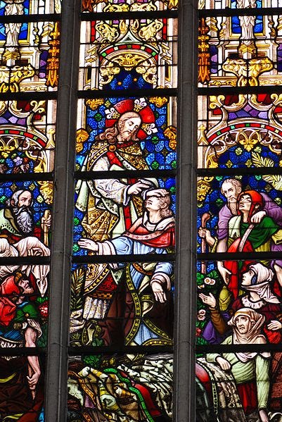 Stained glass depiction from St. Baavo Cathedral in Ghent of Jesus healing the sick