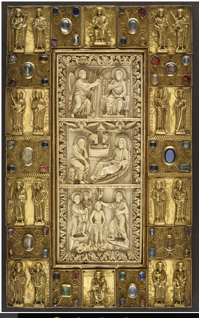 Front cover of the Trier Binding, a jewelled Gospel Book with an ivory plaque in centre and metal borders composed of square panels with figures in relief and filigrees set with stones. The ivory plaques are German work of the tenth century. The panels are early thirteenth or late twelfth century.