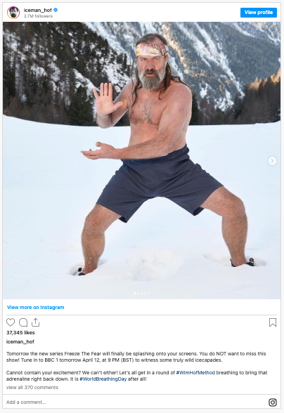Photo of Wim Hof standing in the snow in a Tai Chi Position