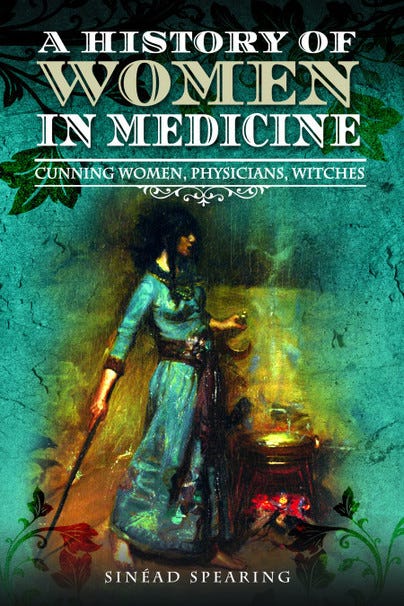 The cover of the book A History of Women in Medicine by Sinead Spearing, showing a woman in an 18th century green dress, holding a hazel wand, standing over a cauldron under which a fire burns