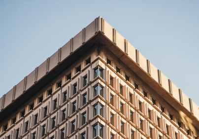 The top corner of a building with a blue sky background