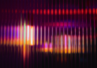 A bunch of vertical, blurred, purple lights on a dark background