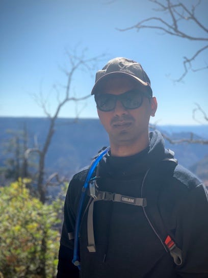 A picture of the top half of Suchit Parikh in his hiking gear