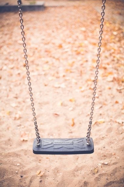 An empty seat of a swing