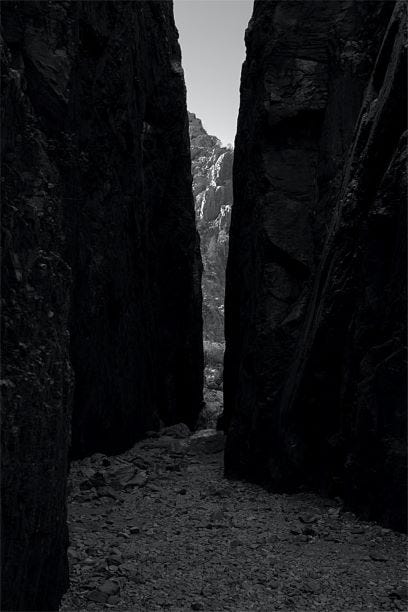 Opening of 2 rock formations and a human dwarfed by their size