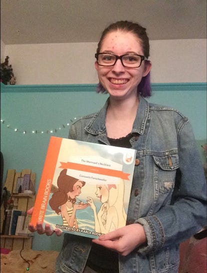 Ferschweiler holding her first self-published children’s book.