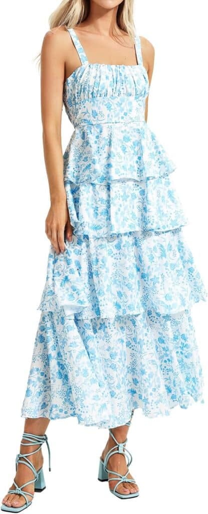 Model wearing a  light blue, floral, maxi length sundress.