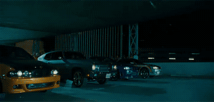 Scene from Fast & Furious, showing the front wheels of a vintage Dodge Charger rising off the ground as a race begins.