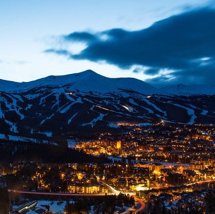 Picturesque view of Breckenridge, Colorado the mountain in the sunset and the city at the base of the mountain.