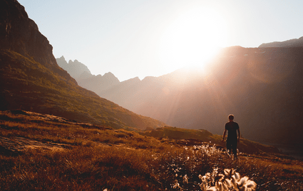 man walking into the sunset in the desert