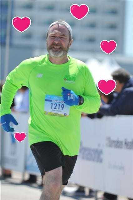 Picture of the author running a marathon with hearts to signify February.