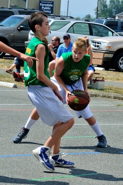 A young Drew McFall plays basketball in a parking lot.