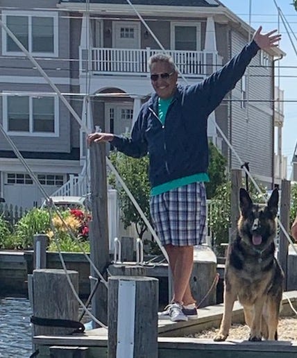 Bill waving from a dock.