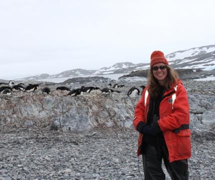WWU’s Suzanne Strom at Palmer Station in Antarctica with penguins in the background.