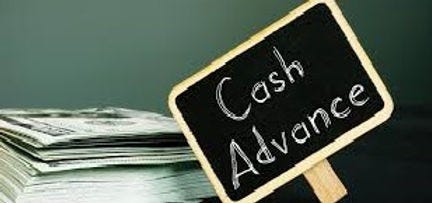 Picture of a stack of USA cash with a small chalkboard that says, “Cash Advance,” on it.