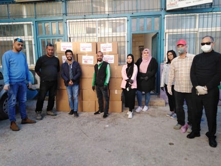 group of volunteers infront of a warehouse