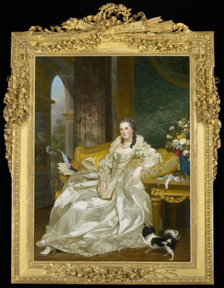 An aristocratic woman poses on a daybed with a small spaniel at her feet.