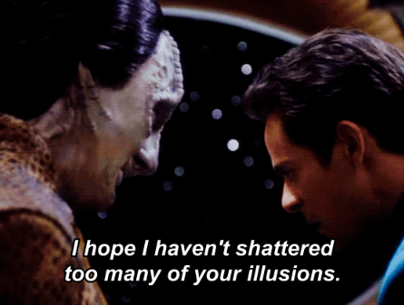 GIF of Garak and Bashir huddled closely. Garak says ‘I hope I haven’t shattered too many of your illusions’ as Bashir listens with his head slightly down.