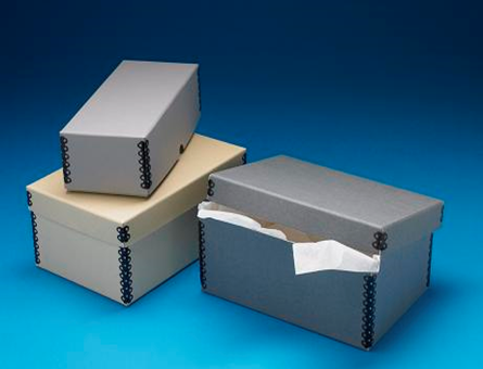 Three boxes of various sizes stacked, with a dark blue gradient background.