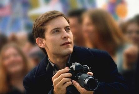 Actor Tobey Maguire holding a camera during the parade sequence in the movie