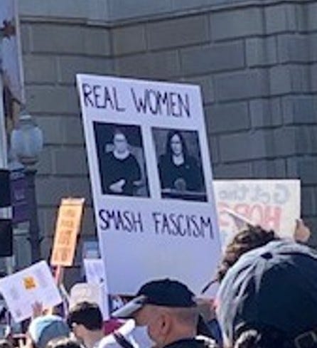 Sign reading “Real Women Smash Fascism”.