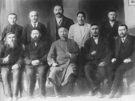 Image of ten men dressed formally, five standing and five sitting, in two rows looking at the camera