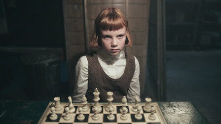 little girl playing chess