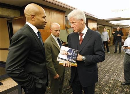 Lakers' Fisher speaks with former president Clinton outside the NBA Players Association meetings in New York