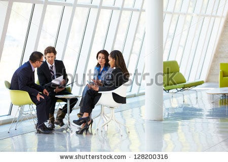 people gathered in stark white office building