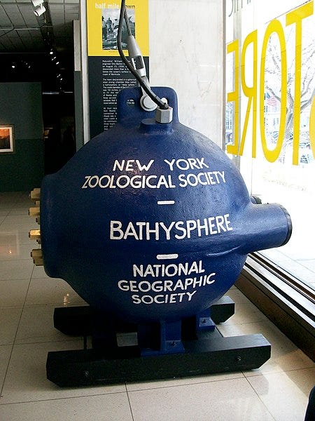A steel sphere bearing the words “New York Zoological Society | Bathysphere | National Geographic Society.”
