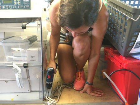 Jessica Kendall-Bar secures the water filtering station before the ship departs San Diego. (Photo: Sarah Yang)