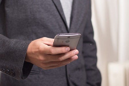 Image showing man using his smartphone.