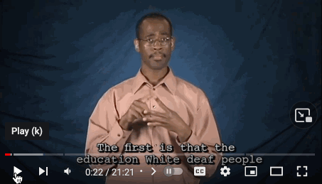 animated gif of a black man signing “The first thing is that the education white deaf people received was better that of black deaf people”