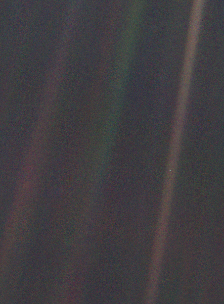 Image of Earth taken from the Voyager spaceflight from roughly the distance of Pluto. Earth looks like a tiny pale blue dot in a sea of space.
