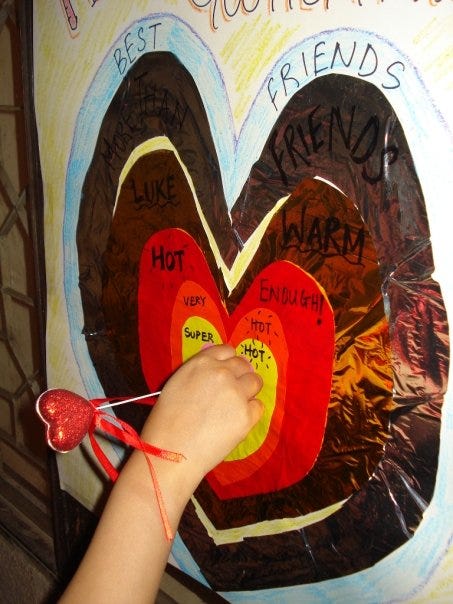 An image of a heart shaped dart board game with concentric hearts