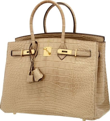 A beige colored Hermes Birkin bag for ladies made from alligator skin.