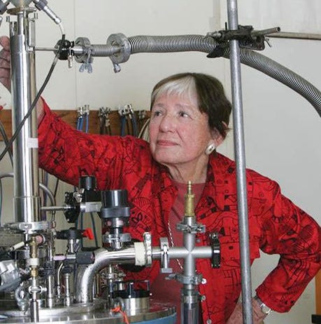 Photo of Myriam Sarachik posing with metal lab equipment