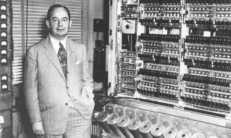 John Von Neumann standing next to a computer from the 1940's