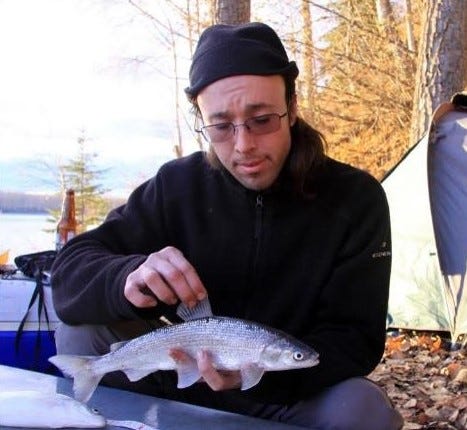 a man holding a fish