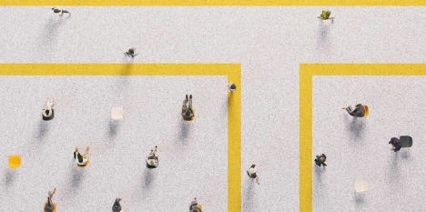 Overhead photo of people walking and sitting in a office