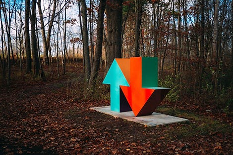 A blue and red up and down arrow statue